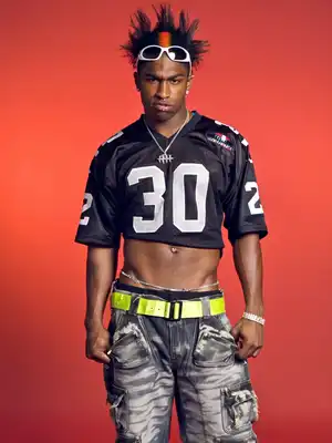 Studio portrait of a model in futuristic sportswear, bright softbox glow, skin-detail focus, silver makeup.